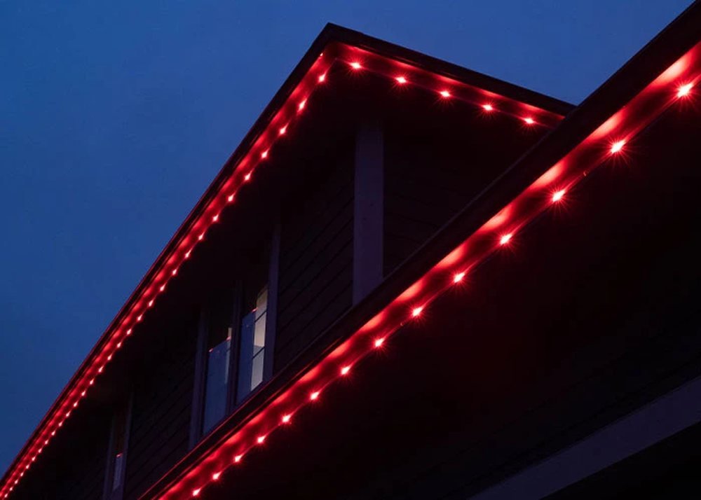 The same roofline lit in red after dark